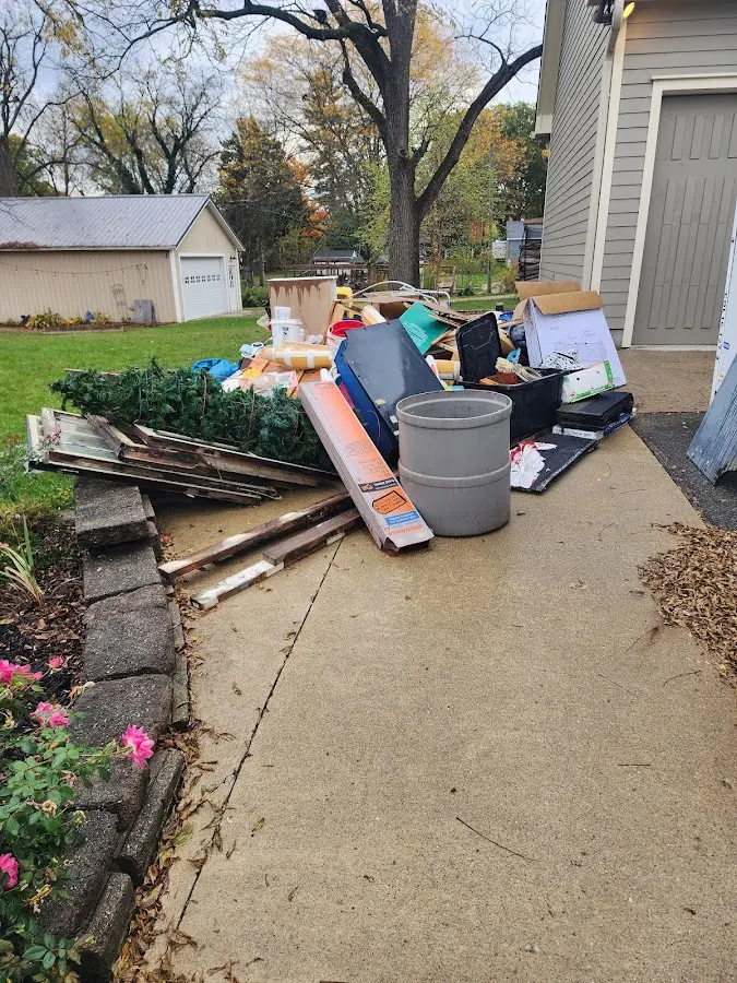 Dumpster being loaded with debris for Estate Cleanout Dumpster Rental in Spartanburg